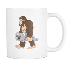 Load image into Gallery viewer, RobustCreative-Bigfoot Sasquatch Carrying Koala - I Believe I&#39;m a Believer - No Yeti Humanoid Monster - 11oz White Funny Coffee Mug Women Men Friends Gift ~ Both Sides Printed
