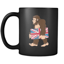 Load image into Gallery viewer, RobustCreative-Bigfoot Sasquatch Carrying Union Jack - I Believe I&#39;m a Believer - No Yeti Humanoid Monster - 11oz Black Funny Coffee Mug Women Men Friends Gift ~ Both Sides Printed
