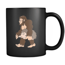 Load image into Gallery viewer, RobustCreative-Bigfoot Sasquatch Carrying Hedgehog - I Believe I&#39;m a Believer - No Yeti Humanoid Monster - 11oz Black Funny Coffee Mug Women Men Friends Gift ~ Both Sides Printed
